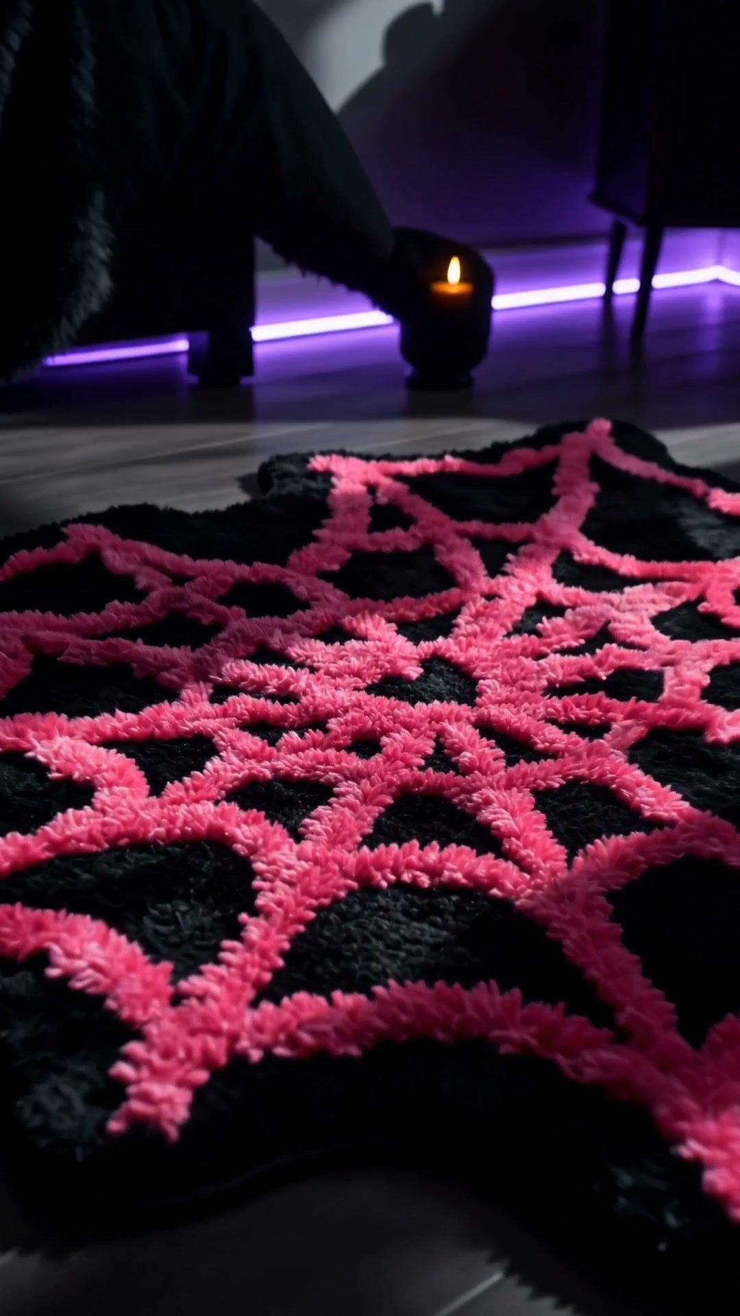 Close-up of plush tufted spider web rug texture in moody room